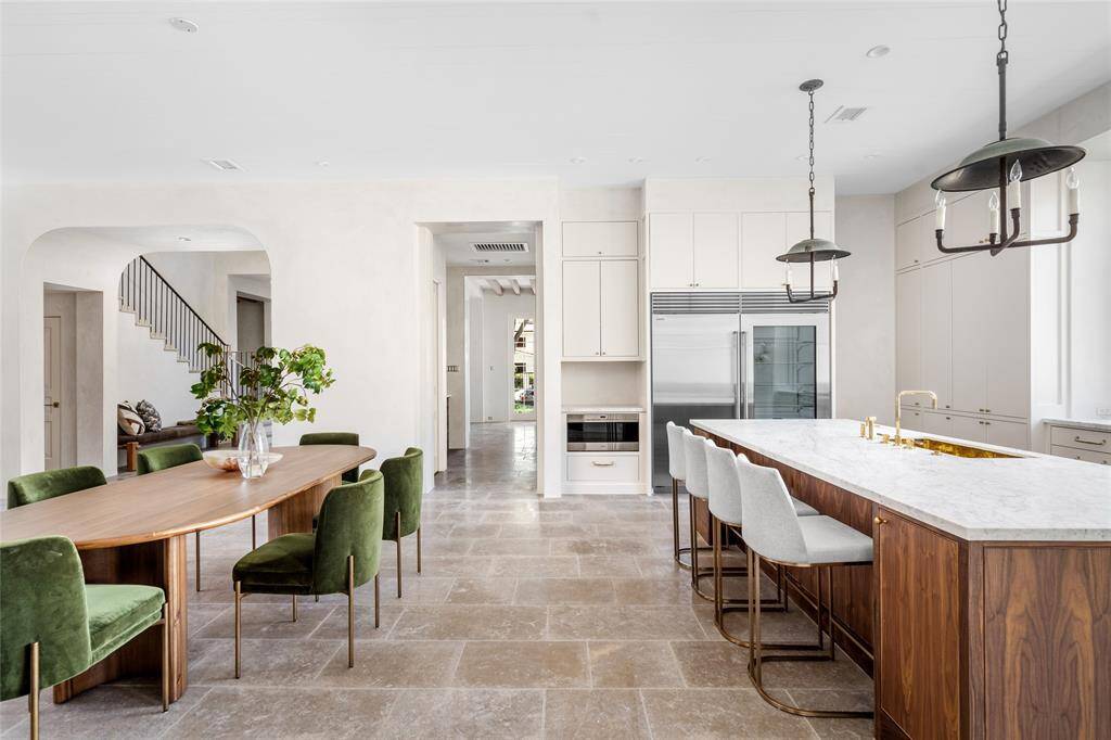 A view of towards the walk-in pantry and the wall of a built-in Wolf microwave and 72 inches of SubZero refrigeration, dual Bosch dishwashers are only some of the exceptional appliances that serve this exceptional home