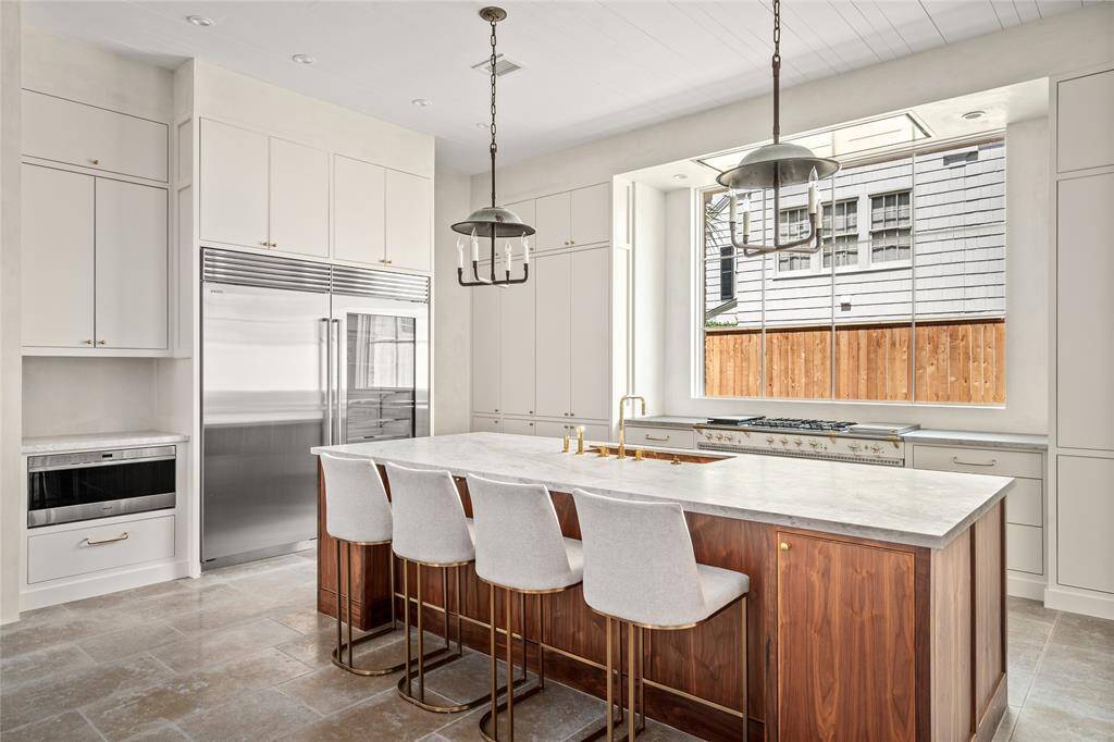 Another view, yet from the Island towards the Great Room and Back Yard with those custom design steel doors that lever open all of the way across