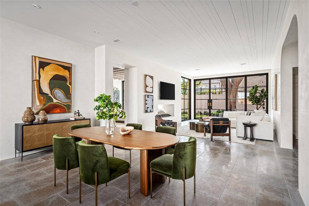 The Lounge with beamed ceiling, artisanal plaster walls, concealed closet under the rear stairs, access to the back yard, antique Italian brass chandelier and a full service bar