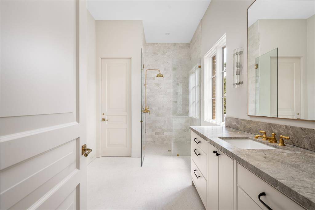 Primary closet (South) and Dressing Room with walnut encased dresser, pull downs and LED lighting