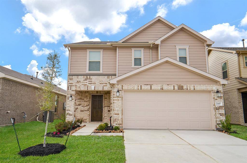 Discover this charming two-story home with a warm, inviting exterior and striking brickwork.
