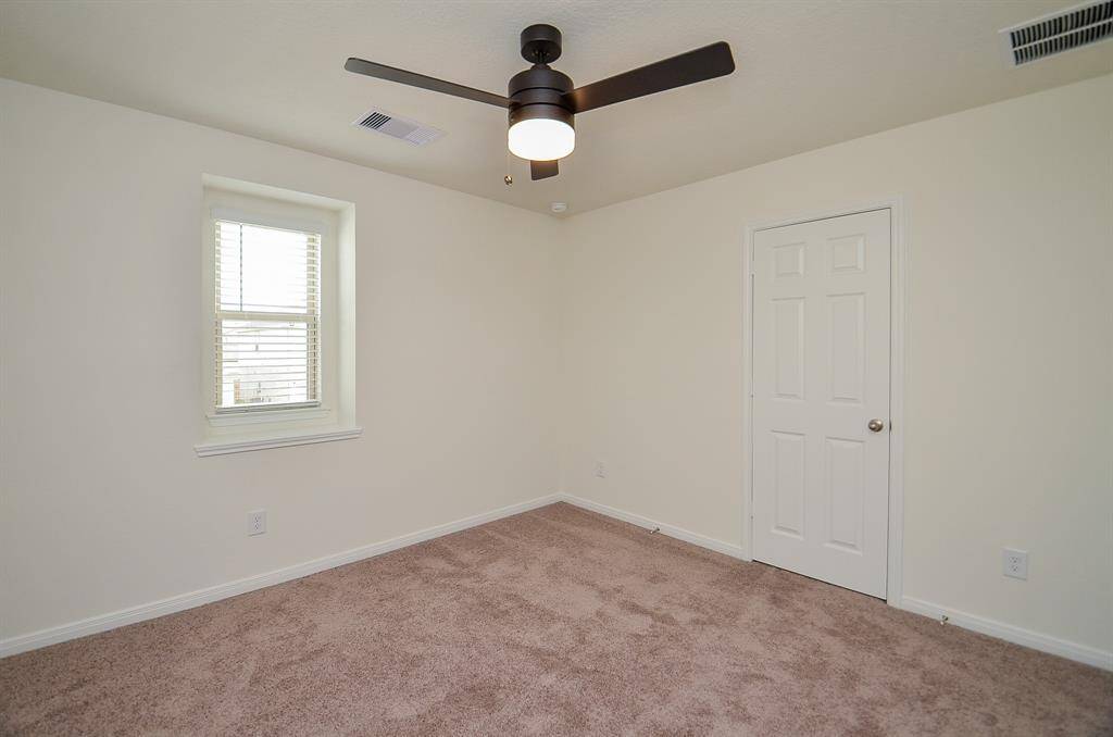 Spacious bathroom with a large vanity and single sink.