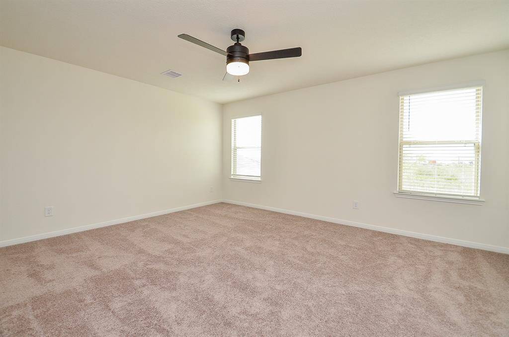 Spacious primary room filled with abundant natural light.