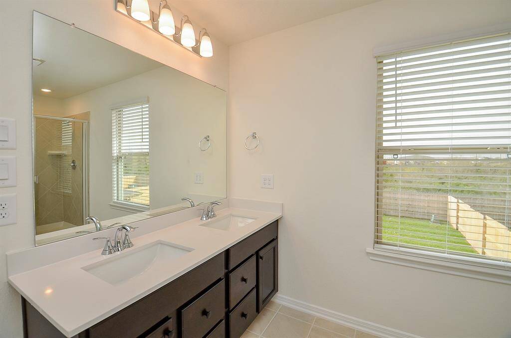 This elegant bathroom features a stand-up shower and a luxurious tub, perfect for relaxation.