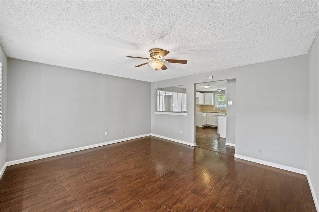 Steps into this entry and living space of this home and you'll notice the flooring, open concept and kitchen.