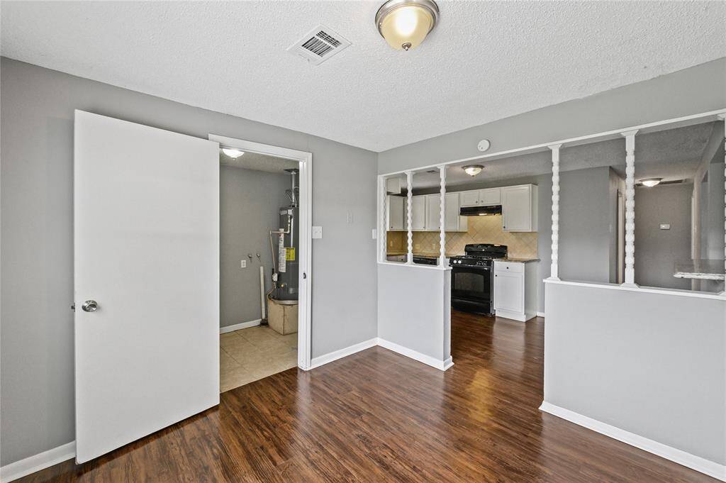 Stepping back out of the primary bedroom, just across the hall is the laundry.