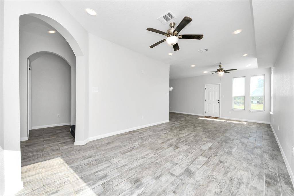 The heart of the home, this spacious living room offers a warm and inviting ambiance. Bathed in natural light, it provides a versatile space for entertaining guests or enjoying quiet evenings with loved ones.