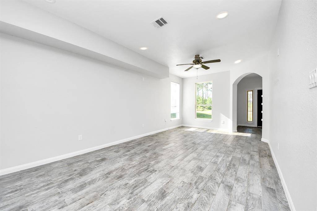 The heart of the home, this spacious living room offers a warm and inviting ambiance. Bathed in natural light, it provides a versatile space for entertaining guests or enjoying quiet evenings with loved ones.