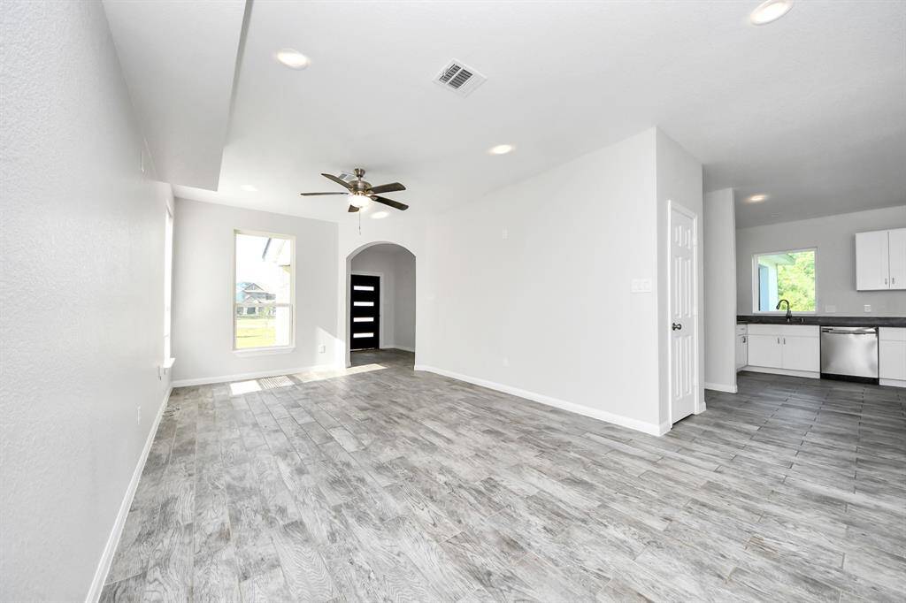 The open concept design seamlessly connects it to the kitchen and dining area, fostering an atmosphere of togetherness.