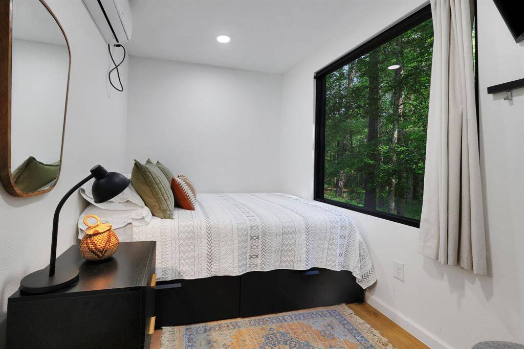The bedroom has a large window to take in the view
