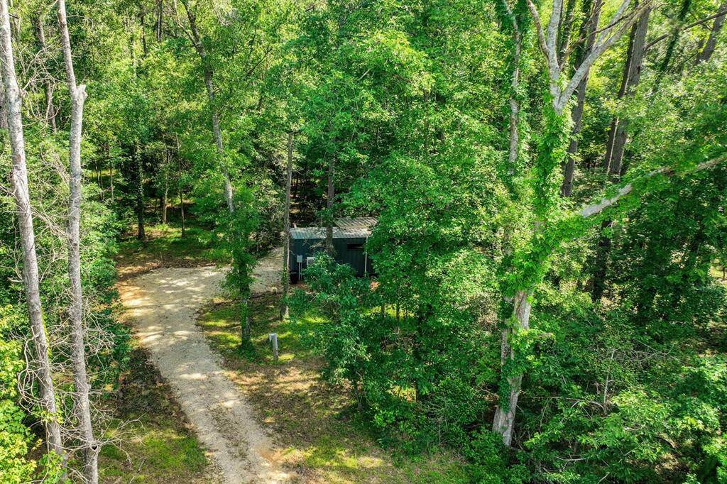 This unique container home is situated on 4.5 wooded acres!