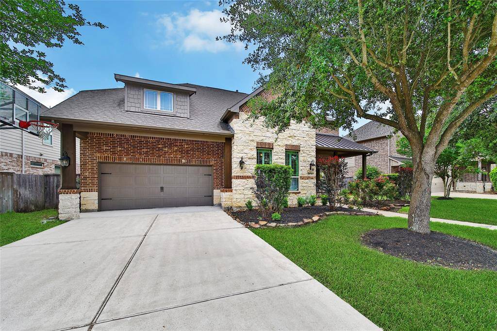 Brick and Stone Elevation with a spacious front porch and a 3 car tandem garage.