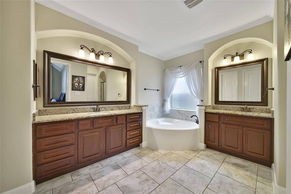 Primary  Bathroom with a jetted tub, seperate sink/cabinets and two spacious closets!