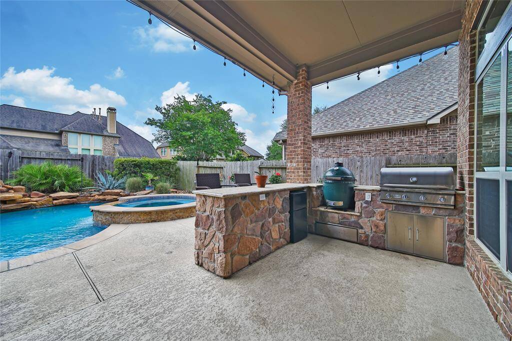 Outdoor kitchen with bar area, plummed with water and gas line