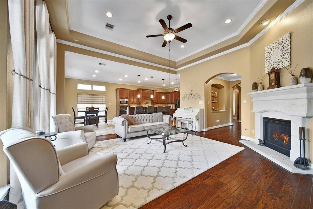 Living room with a gas log fireplace and a wall of windows giving you a view to the backyard oasis!