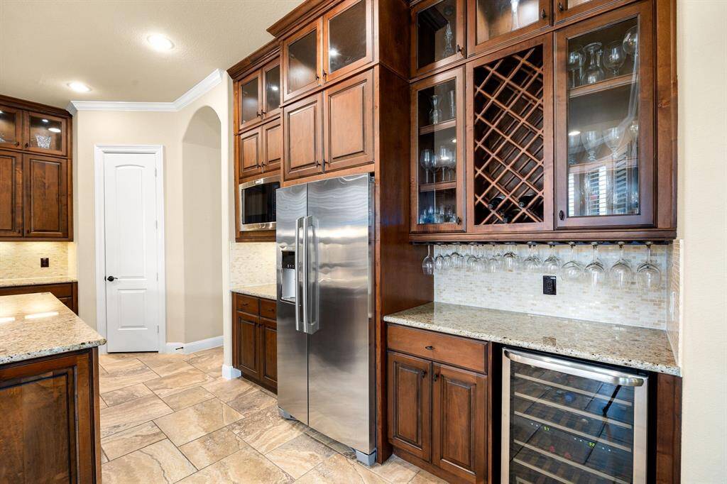 This unique and special part of the kitchen showcases the bar including a wine fridge, wine display holder and plenty of space to hold all your glasses. Perfect for gatherings or just a wine night between you and your family!