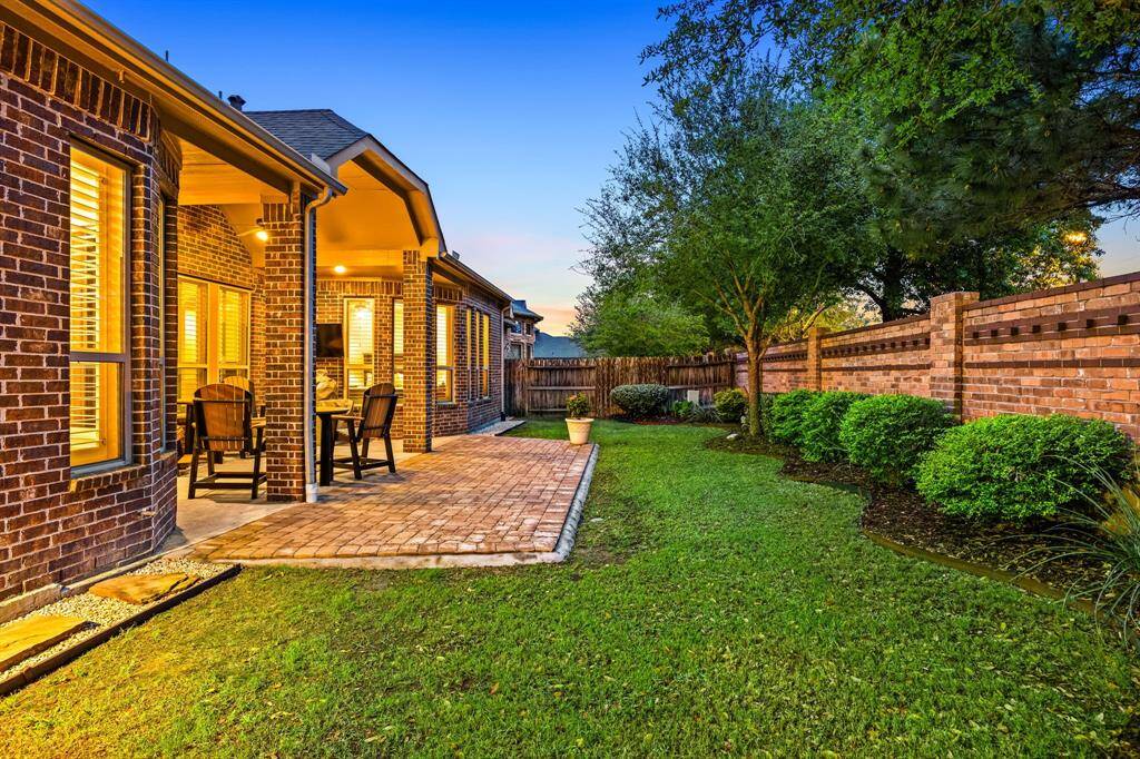 From the backyard, admire the brick exterior and extended patio that seamlessly blend indoor comfort with outdoor enjoyment.