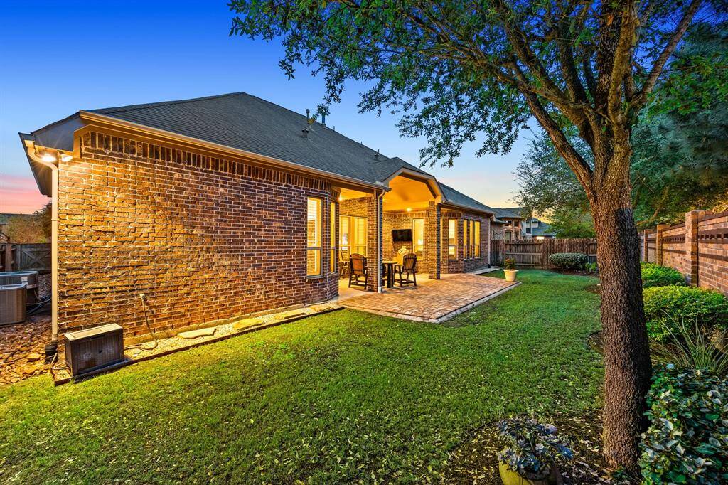 Lush, manicured greenery surrounds the home, creating a serene space for family fun and entertaining.