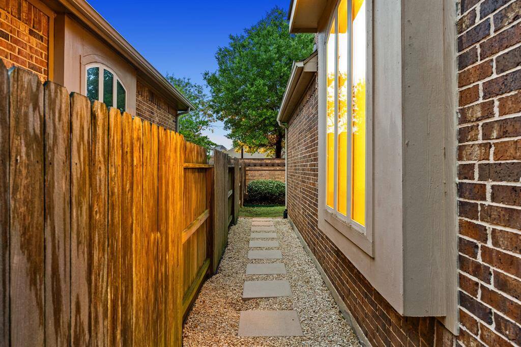 Convenient stepping stones along the side of the house provide easy access while adding style to the low-maintenance walkway.