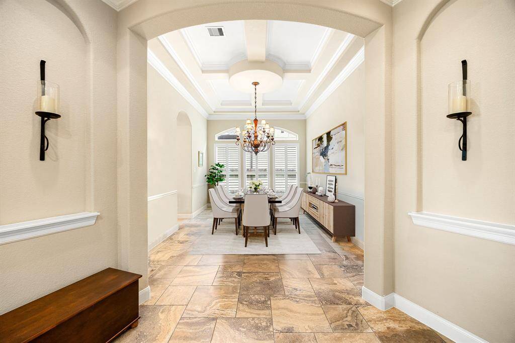 Entertaining is effortless in this inviting formal dining room, featuring a soaring tray ceiling, elegant chandelier, and abundant natural light for a truly memorable gathering space. *Virtually Staged