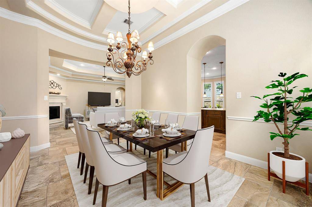 Make memories gathered around the table with your family and friends! This dining room features high ceilings, crown molding, chair rail, large windows, tile flooring and a beautiful chandelier. *Virtually Staged