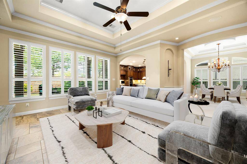Gather the family and guests together in your lovely living room! Featuring soaring high ceilings, recessed lighting, dark stained ceiling fan, custom paint, gorgeous tile floors and large windows that provide plenty of natural lighting throughout the day. *Virtually Staged