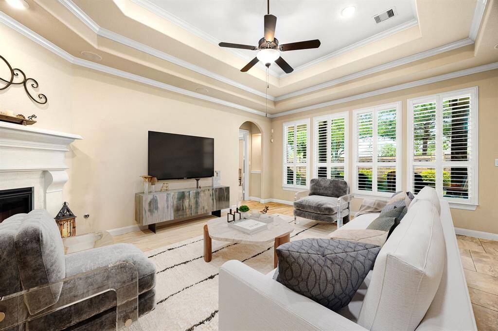 This light and bright spacious living room is the perfect layout for entertaining or just relaxing. Whether it's simply a night in or entertaining family and friends, this home has ample open space for everyone to enjoy! Featuring dark stained ceiling fan, large tile flooring, large windows with shutters, soaring high ceilings, recessed lighting with wonderful access to your gorgeous kitchen. *Virtually Staged