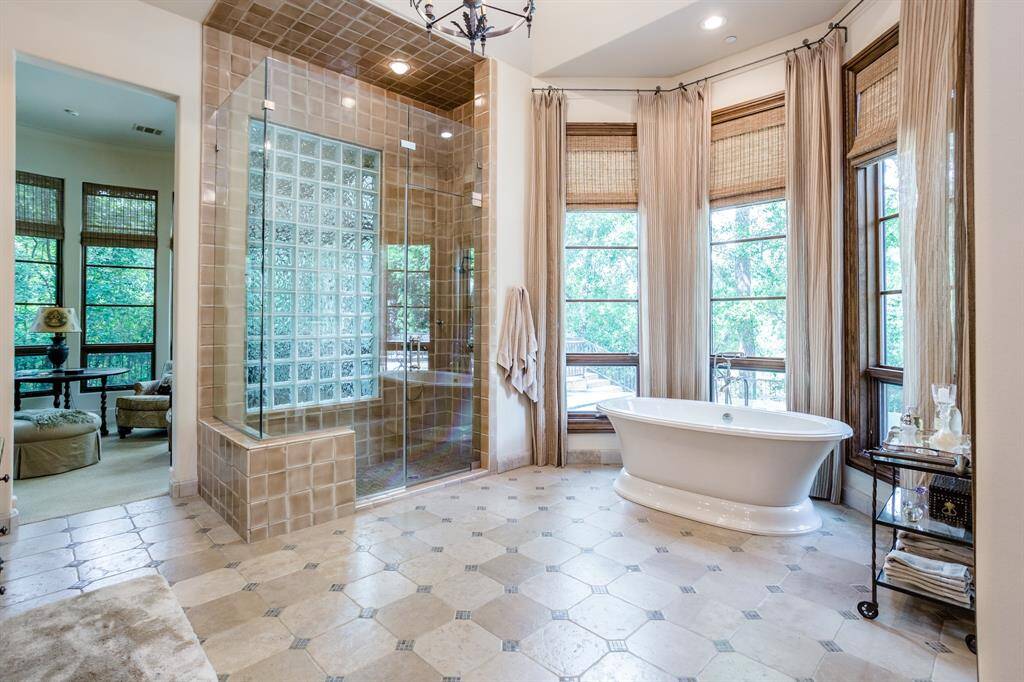 Huge Primary Bath. Tons of windows to let in the light and to enjoy the secluded setting high above Buffalo Bayou.  Walk in shower. Jetted tub.  Private sitting area or work out space off of Primary Bath.