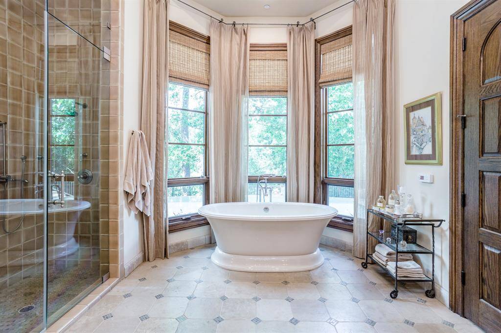 Huge Primary Bath. Tons of windows to let in the light and to enjoy the secluded setting high above Buffalo Bayou.  Walk in shower. Jetted tub.  Private sitting area or work out space off of Primary Bath.