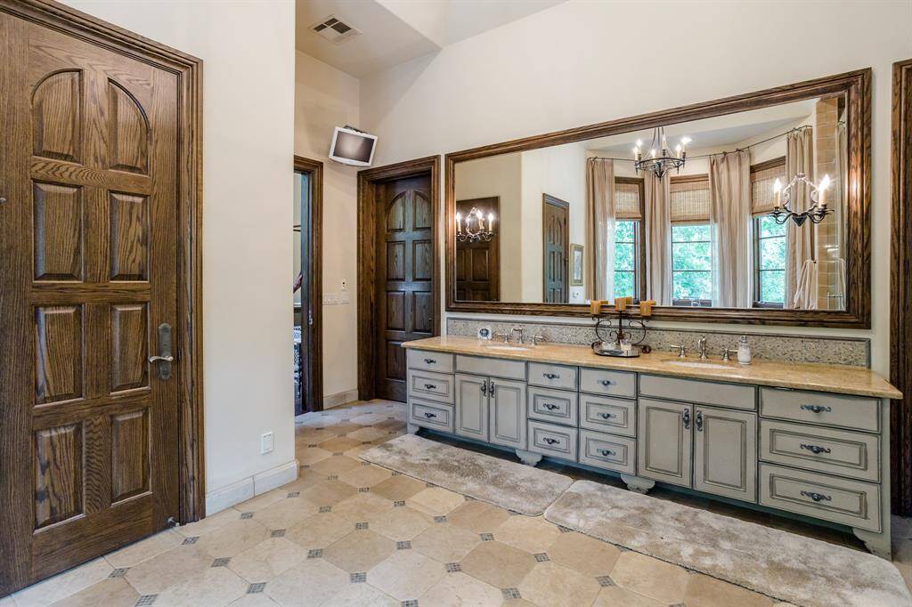Huge Primary Bath. Tons of windows to let in the light and to enjoy the secluded setting high above Buffalo Bayou.  Walk in shower. Jetted tub.  Private sitting area or work out space off of Primary Bath.  Custom designed & painted vanity.