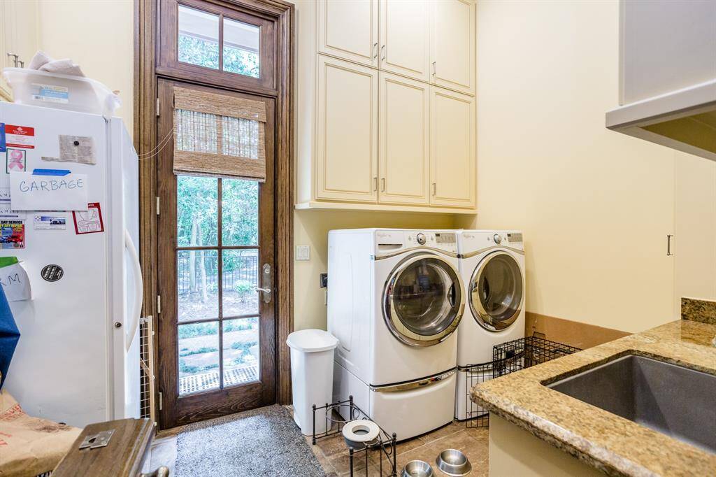 Spacious laundry and pet area.  Easy access to side yard. Floor to ceiling windows to let in the light and all pooches to look out the window.  This room also features a Dutch door so the pets can be enclosed in the room but allowed to hear what's going on.