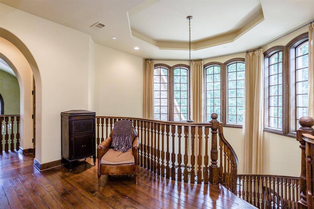 Second floor landing. White oak hardwood floors. Custom crafted and built on-site curved staircase. Tons of light.