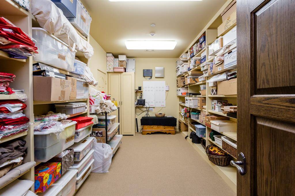 Second Floor air conditioned storage room 18' x 9'.  Built in shelves. Technology Closet.  Access door to attic.