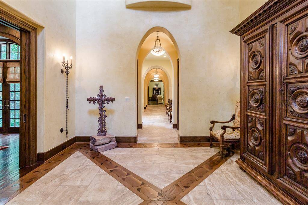 Foyer with Living Room to the left. Pillowed travertine flooring. Multiple wood inlaid flooring.