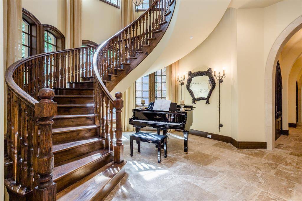 Custom built on-site, white oak, free-standing staircase.  Pillowed travertine flooring. Floor to ceiling windows.