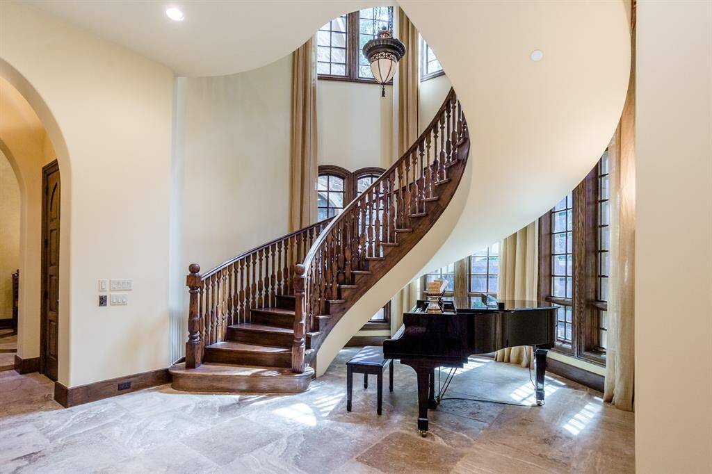 Gorgeous freestanding, custom built on-site staircase. Tumbled travertine floors. Floor to ceiling windows to let in the natural light and showcase the secluded exterior setting.