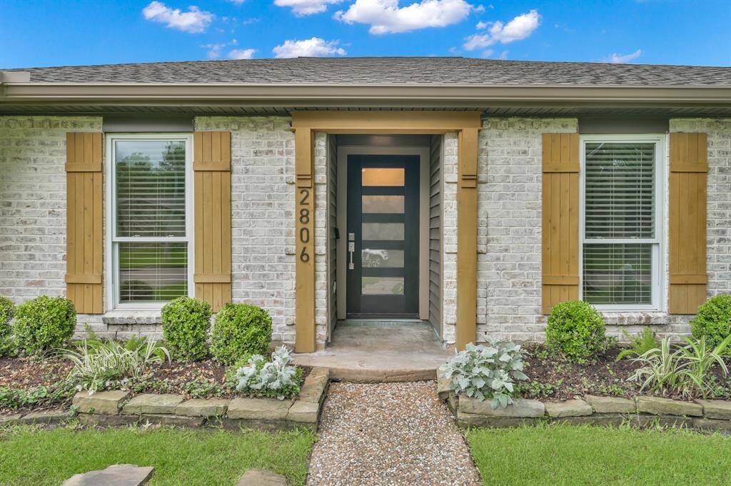 German-schmear exterior brick with custom cedar shutters , brand new designer front door and meticulous landscaping create amazing curb appeal.