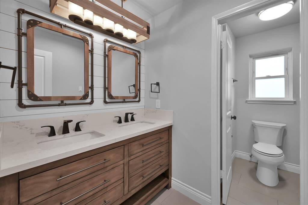 Secondary bath with dual updated vanities.