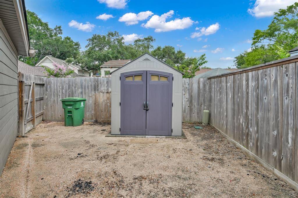 Extra storage space and shed is tucked behind the garage.