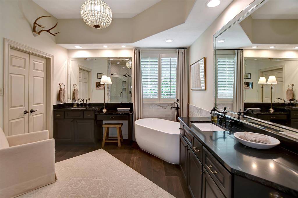 Luxurious master bath featuring recently renovated with Calacatta marble, herringbone pattern subway tile shower, and a stunning deep spa style tub.