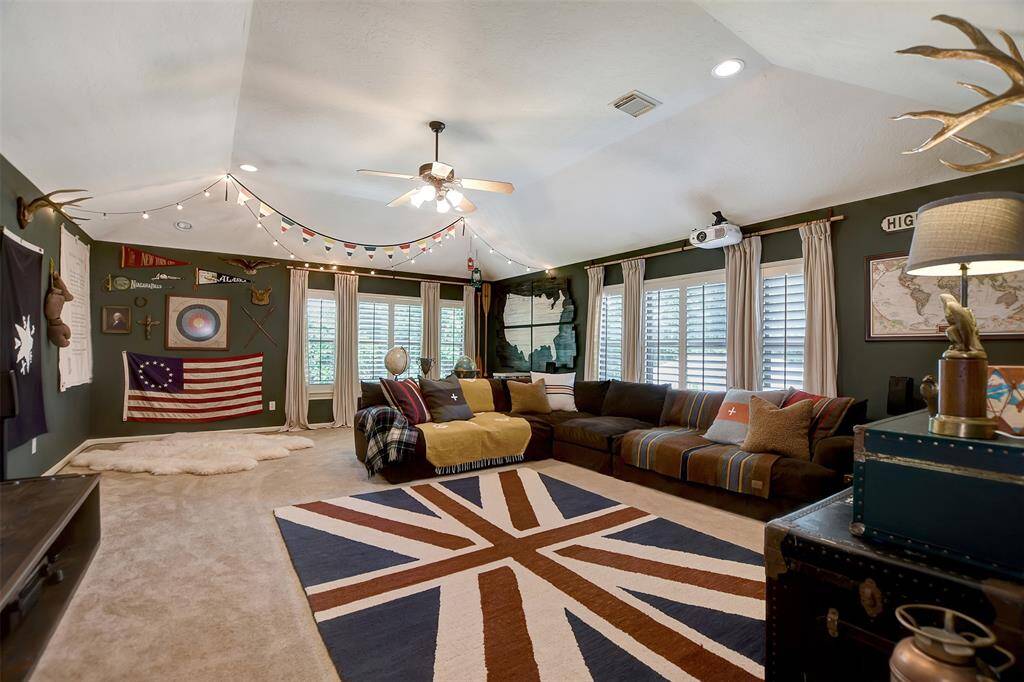 Spacious bonus room upstairs currently set up as a game and media room with a projector and projector screen that will stay with home. This versatile space could easily serve as a fourth bedroom if desired.