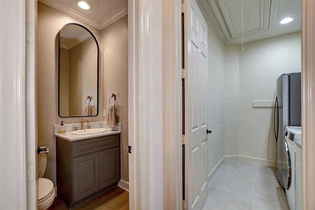 To the right of the study is a stylish space featuring a convenient half bath and an efficient laundry room.