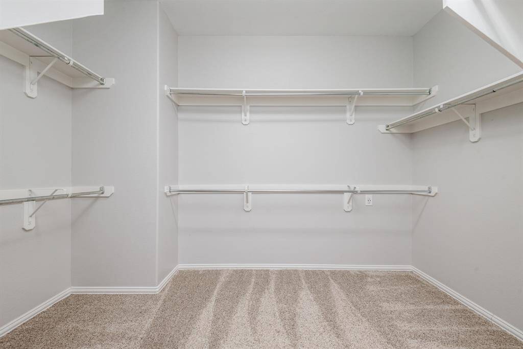 Primary bedroom ensuite with double sinks, soaking tub, separate shower, plantation shutters and large walk in closet.