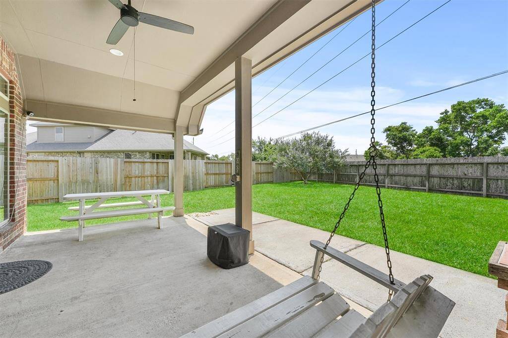 Oversized covered back patio perfect for a night of entertaining or unwinding after work!
