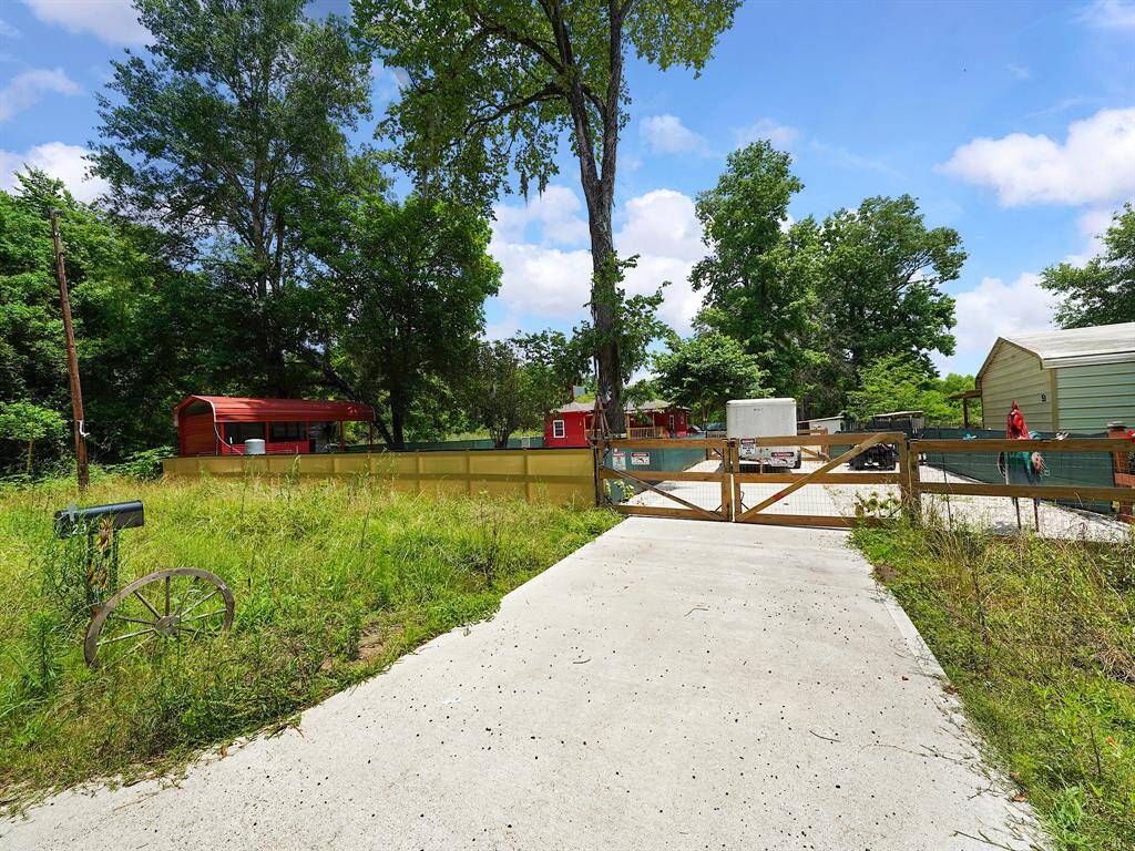 The gated entrance and private driveway set a rural tone, framed by trees and fencing. From the moment you arrive, the property exudes countryside appeal.