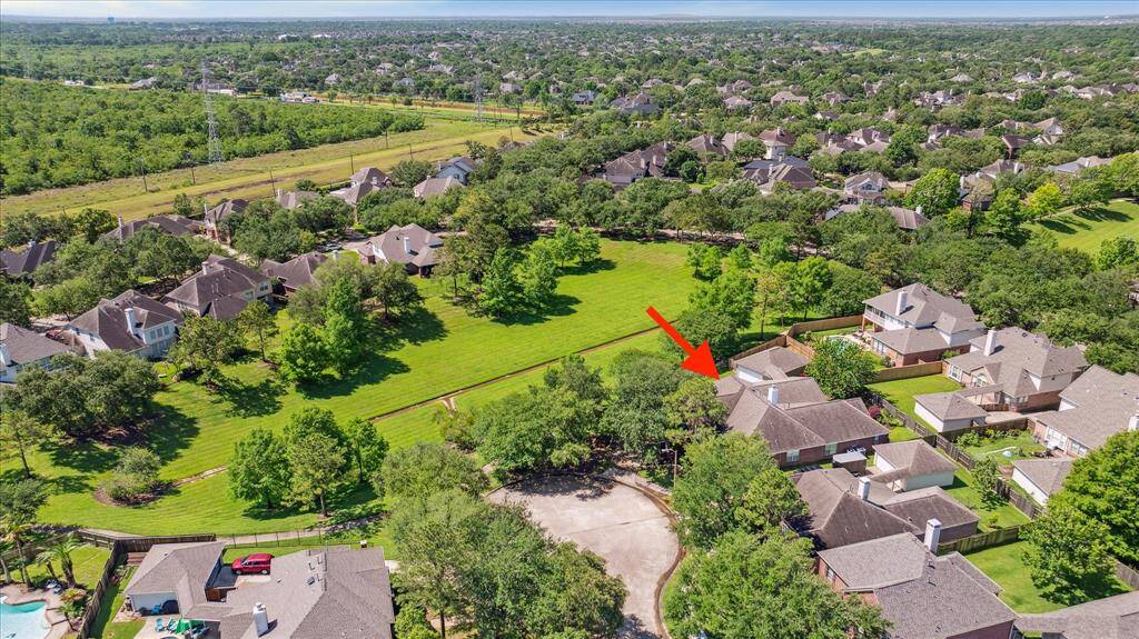Here's an aerial view of your new place! You're at the end of a cul-de-sac and adjacent to the greenspace. This home has never flooded. The water flowed away from the house during Harvey and it all drained quickly. You can also exit the neighborhood onto W Bay Area Blvd. to get to Kroger (right) and the community pool (left)