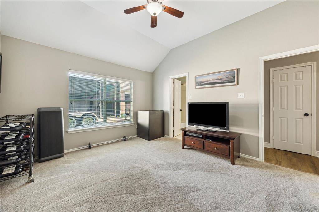 Here's the last of the secondary bedrooms. There are two closets in the hallway and one directly behind us. The open door beyond the TV leads to a bath.