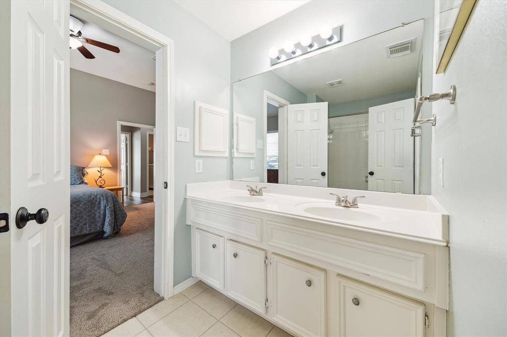 There's a tub/shower combination reflected behind us and a dual vanity in the bath that sits between the middle and rear secondary bedrooms.