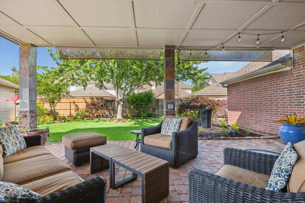 This is one of my favorite parts of this property. You will love sitting outside and enjoying the shade. There are two fans and two roller shades if you want to add more screening.