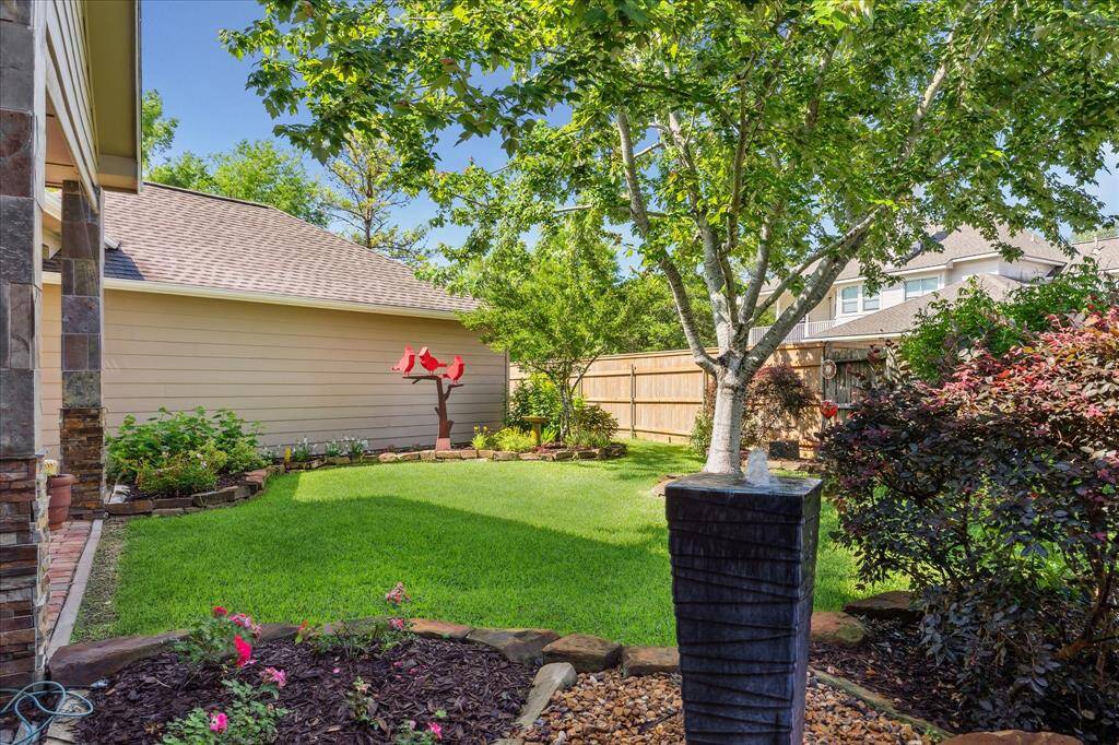 Here's a view of the edge of the patio and the side of the garage. You can see a little bit of the garden. The statuary and yard art will not stay.